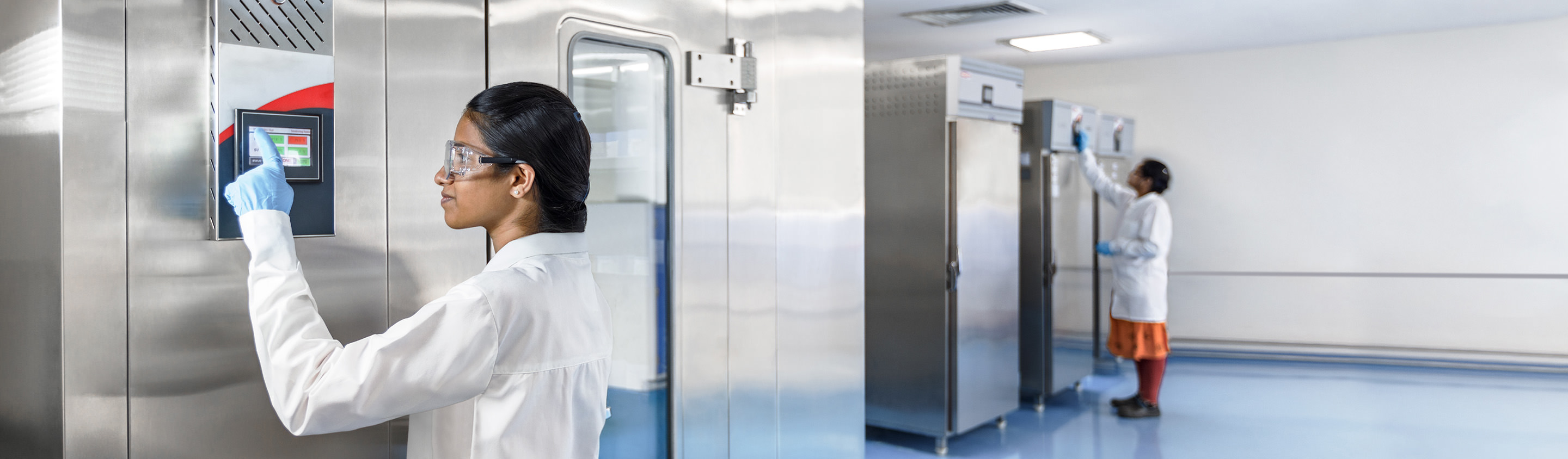 Aragen analyst placing samples into a stability chamber in a stability studies laboratory