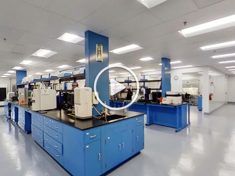 Virtual tour: interior of Aragen's biologics laboratory with blue benches and analytical instruments (video)