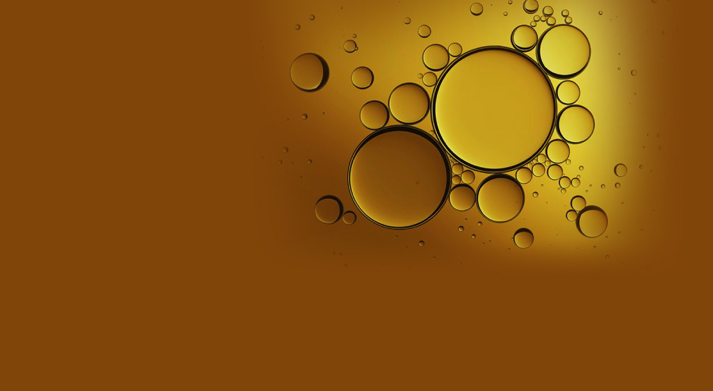 Close-up of golden oil droplets and bubbles, representing a solid dispersion or emulsion formulation