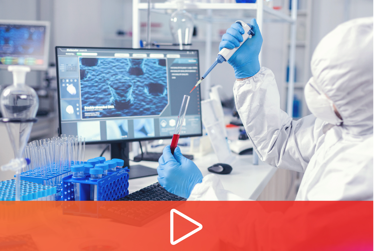 Scientist in cleanroom gown pipetting beside a microscope screen, discovery biology video thumbnail